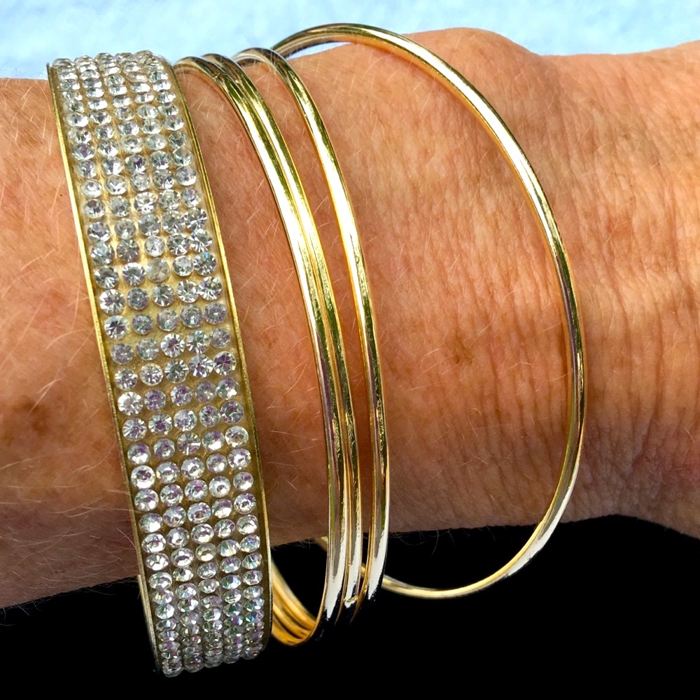 Set of 5 brackets. 4 thin & 1 rhinestone bangle.